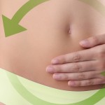 woman hands on belly with green arrow